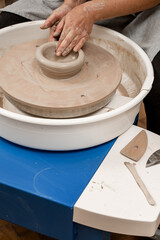 Forming the proper size and shape of pottery with increasing speed of a pottery wheel. Making a bowl on a pottery wheel with your own hands.