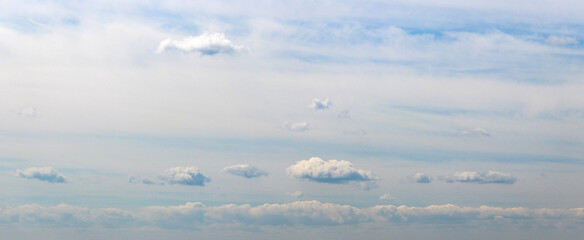 Small white fluffy clouds float across the sky