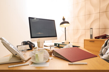 Messy workplace with computer monitor and garbage in office