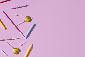 Different Birthday candles on lilac background