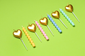 Different Birthday candles on green background
