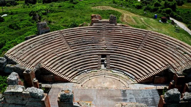 Top down aerial drone shot of the Theatre of Dodona in the Epirus region in Greece. Drone view over ancient historical greek amphitheater. Archaeological site.