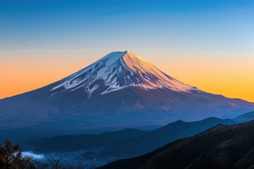 Fototapeta premium A stunning view of a snow-capped mountain at sunset, showcasing vibrant colors and dramatic landscapes.