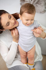 mother standing holds the child in her arms