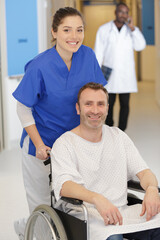 Fototapeta premium nurse taking care of patient in wheelchair