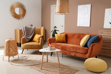 Interior of living room with armchair, cozy sofa and coffee table