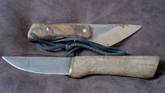 a kiridashi knife and a puukko knife with a wooden handle