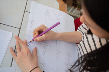 Woman hands writing, drawing with pencil close up. German wort möchte translated as like. placate...