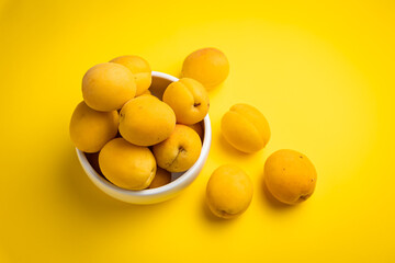 Ripe apricots on a yellow background. Healthy food.