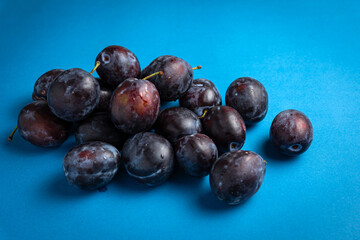 ripe plums on a dark background. Close up
