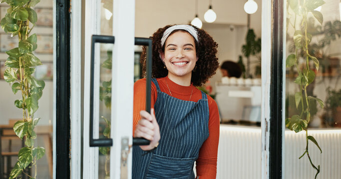 Portrait, welcome and woman at coffee shop door for opening with friendly smile of hospitality. Cafe, entrance and retail with happy restaurant owner or waitress at store for greeting or service
