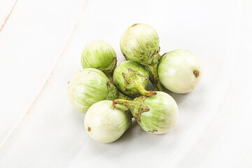 Small organic young green round eggplant