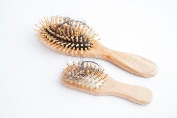 Asian woman have problem with long hair loss attach to comb brush.