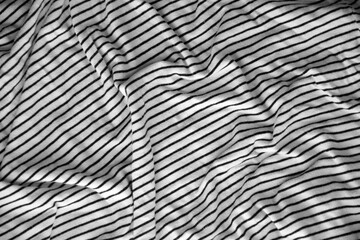 Processed collage of abstract black and white stripped cloth background with many folds