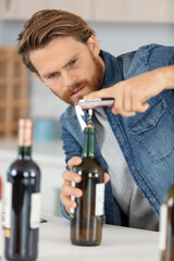 man opening bottles of wine