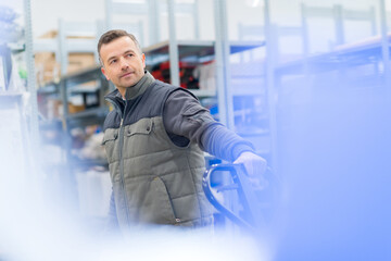 warehouse worker pulling a pullcart