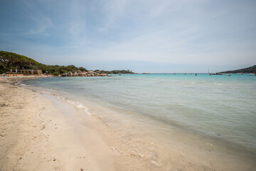 Holidaymakers enjoying the sun, sand and azure Mediterranean sea at Santa Giulia beach on the south east coast of the island of Corsica