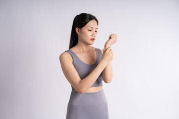 Portrait of Asian woman wearing sportswear, posing on white background