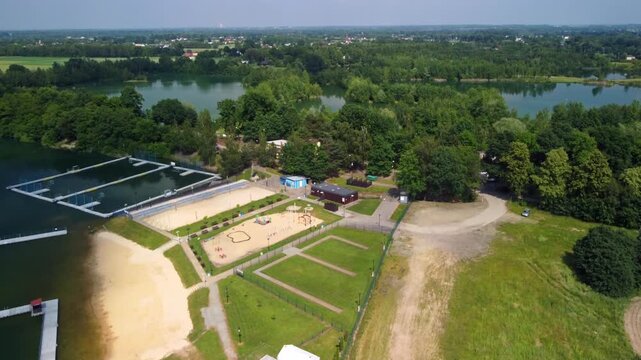 Aerial Drone rises up Over Natural Swimming Pool During Daytime In Kaniow, Poland.