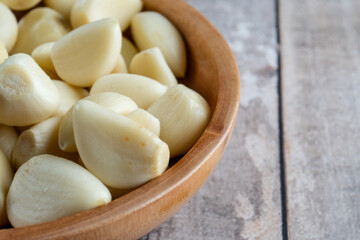 close up shot of half bowl of garlic