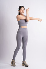 Portrait of Asian woman wearing sportswear, posing on white background.