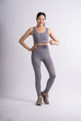 Obraz premium Portrait of Asian woman wearing sportswear, posing on white background.