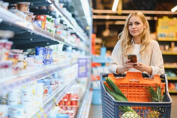 Young woman doing grocery shopping at the supermarket