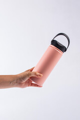 Pink bottle tumbler and hand isolated on white bakcground