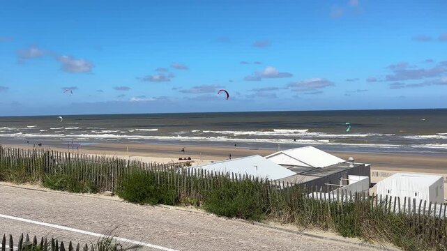 Kitesurfing on Zandvoort aan Zee beach on a Summer day. Popular North Sea resort in the Netherlands.