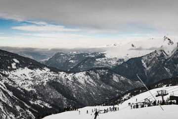 Skiers on a snowy slope in a French Alps ski resort
