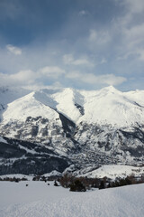 Small village nestled between enormous snowy mountains