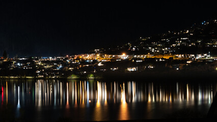 little town at night, with reflection of lights in the water