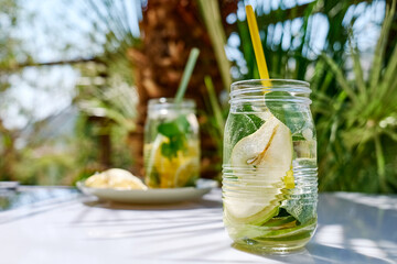 Detox drink. Infused water with pear, lime and sage. Refreshing summer homemade cocktail. Fresh...