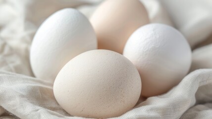 close-up of four fresh white and brown eggs on white linen fabric - minimalist kitchen food graphy for recipe or cooking blog.
