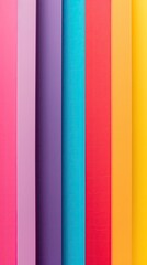 Obraz premium A vibrant display of colorful paper sheets arranged vertically, showcasing a spectrum of bright hues, perfect for creative projects.