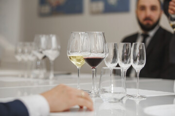 Layout of wine glasses on the table, preparing for the tasting of alcoholic beverages. Preparation to blind wine degustation for beginners sommelier. Wine school, winemaking lecture.
