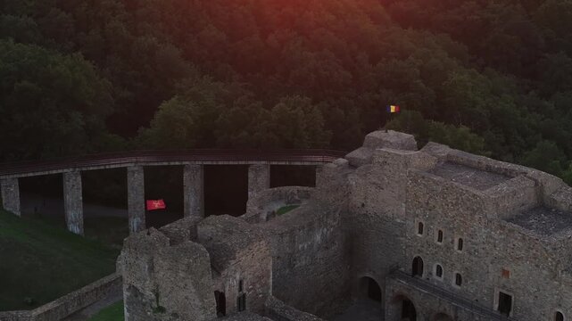 Neamt Fortress (Cetatea Neamtului in Romanian language). 4K aerial close up video with a beautiful sunrise over this iconic fortress from Moldova, Romania. Travel to Romania history landmarks.
