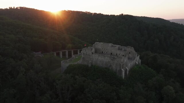 Neamt Fortress (Cetatea Neamtului in Romanian language). 4K aerial close up video with a beautiful sunrise over this iconic fortress from Moldova, Romania. Travel to Romania history landmarks.