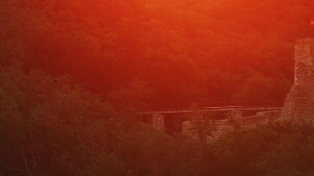Neamt Fortress (Cetatea Neamtului in Romanian language). 4K aerial close up video with a beautiful sunrise over this iconic fortress from Moldova, Romania. Travel to Romania history landmarks.