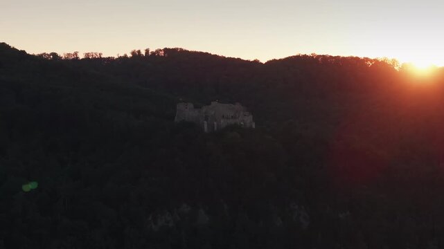 Neamt Fortress (Cetatea Neamtului in Romanian language). 4K aerial close up video with a beautiful sunrise over this iconic fortress from Moldova, Romania. Travel to Romania history landmarks.