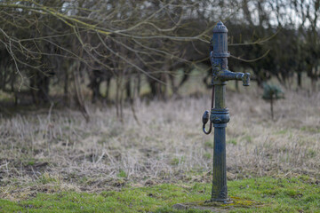 Old technology - a Victorian stand-pipe or hand pump for water in a field in North Yorkshire, UK. Horizontal landscape format.