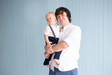 Father playing with his little toddler child baby boy son. Happy modern family