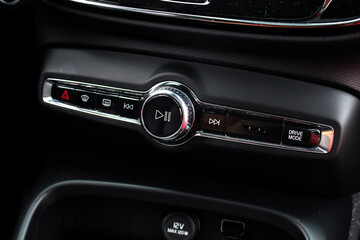 Fototapeta premium Car multimedia system. Modern car dashboard. Radio on control panel system in car. Multimedia control system. Interior detail.