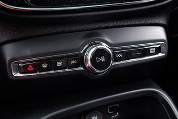 Sound and multimedia control buttons in the new electric car. New car dashboard. Multimedia control...