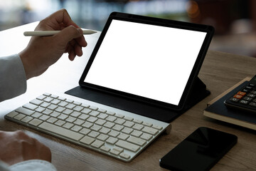A businessman holds a mockup. iPad digital tablet with blank screen Mockup replaces your design mockup in the office.