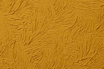 Gold textured wallpaper pattern with swirls in close up