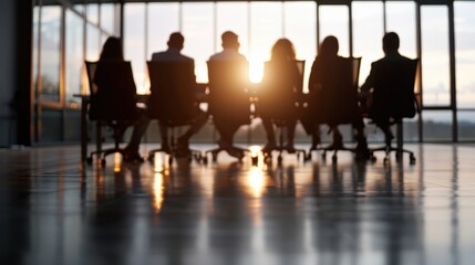 Six business people sit at a long table in a modern conference room during a meeting. Their silhouettes are visible against a setting sun through large windows, symbolizing teamwork.