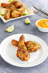 Baked Chicken Drumsticks with Condiment Garnished with Fresh Thyme and Lemon