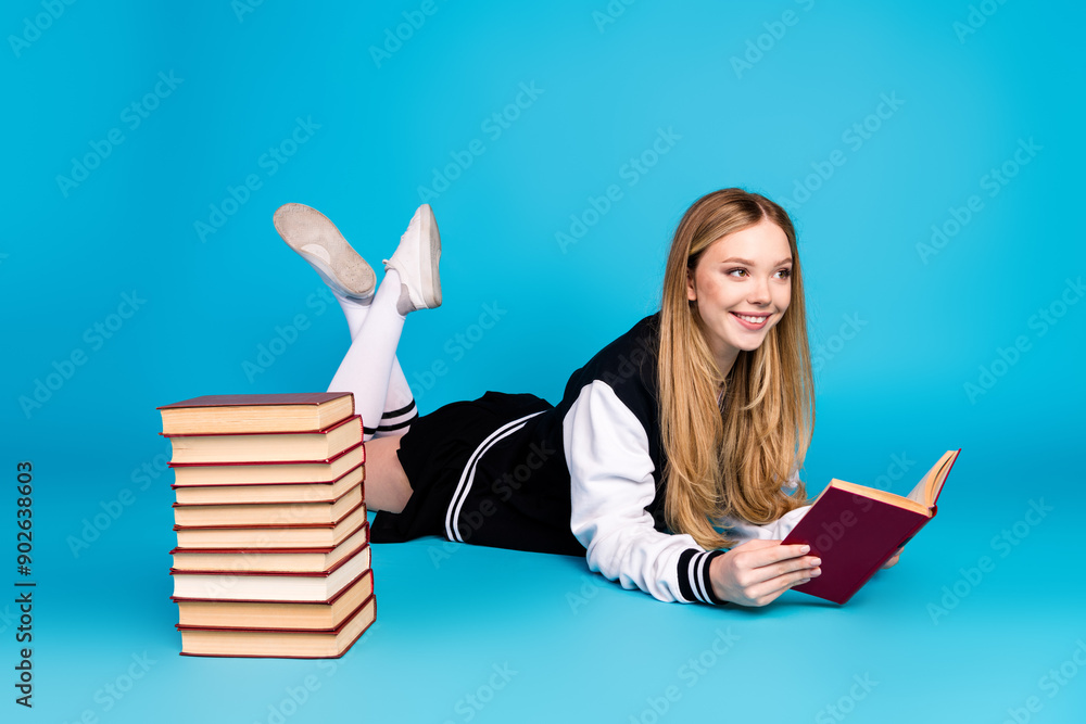 Sticker Photo of cute charming pretty clever girl wear trendy clothes long socks lie floor look empty space isolated on blue color background