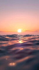 Obraz premium Sunset with calm ocean waves and a golden sky.